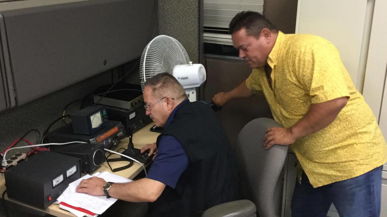 Raul Gonzalez and Jose Santiago work to maintain the communication infrastructure they set up between ham radio operators in the Monacillo Control Center.