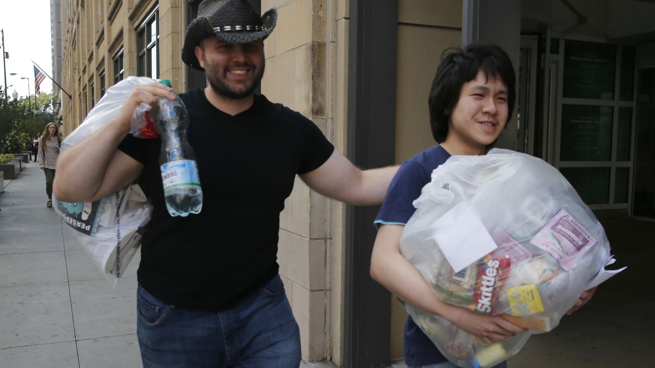 Amos Yee, a teenage blogger from Singapore, right, leaves the US immigration field office with his friend Adam Lowisz, Tuesday, Sept. 26, 2017, in Chicago.