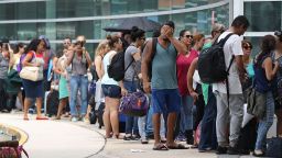 SAN JUAN, PUERTO RICO - SEPTEMBER 26:  People wait in line to get a flight out of the Luis Munoz Marin International Airport as they try to return home or escape the conditions after Hurricane Maria on September 26, 2017 in San Juan, Puerto Rico.  Some of the people have waited days at the airport in hopes of getting onto a plane after Hurricane Maria, a category 4 hurricane, devastated the island.  (Photo by Joe Raedle/Getty Images)