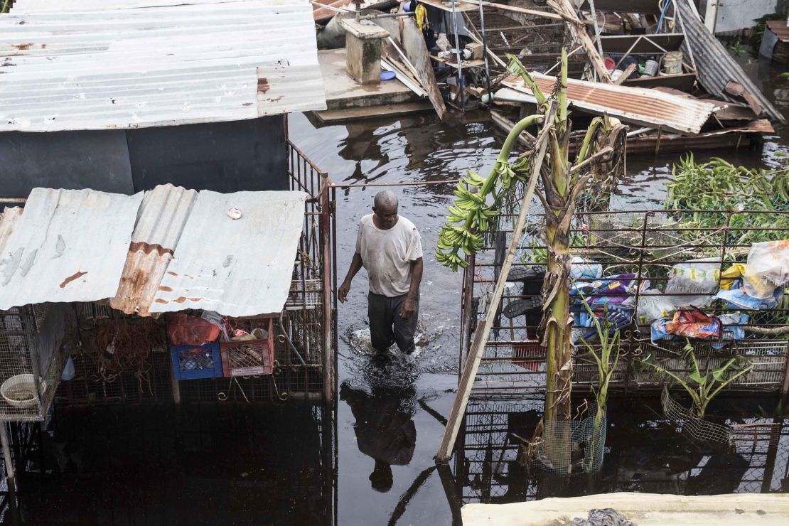 A resident wades through floodwaters after Hurricane Maria made landfall in Loiza, Puerto Rico.