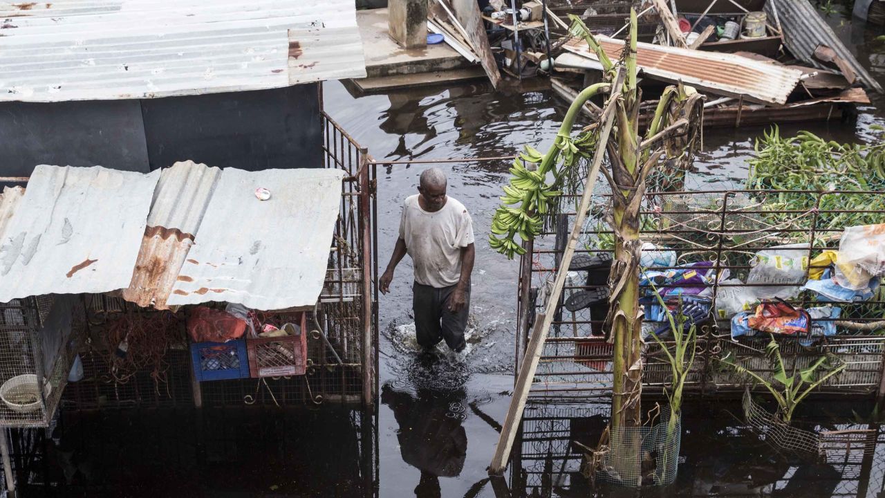 LOIZA, PUERTO RICO - SEPTEMBER 22: A resident wades through flood water days after Hurricane Maria made landfall,  on September 22, 2017 in Loiza, Puerto Rico. Many on the island have lost power, running water, and cell phone service after Hurricane Maria, a category 4 hurricane, passed through. (Photo by Alex Wroblewski/Getty Images)