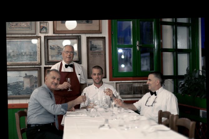 <strong>Grandpa's photos -- Romano's, Burrano, Italy -- present day:</strong> Clarke, pictured center recreating the Italian restaurant scene, says people have responded to the familial message at the heart of the project: "Anyone can relate to it I think."