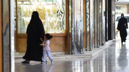 Saudi women walk past jewelry shops at Tiba market in Riyadh, on October 3, 2016.