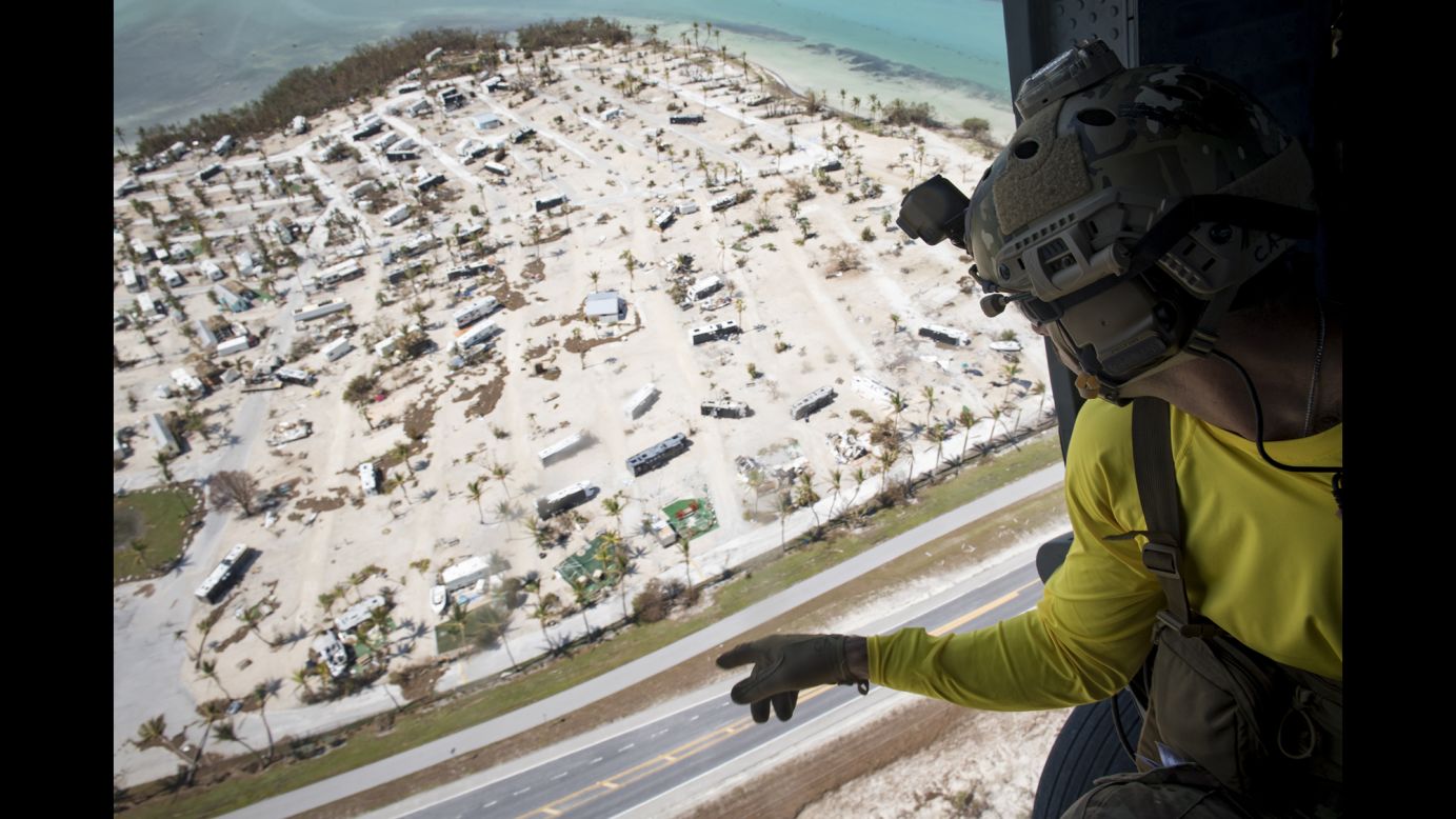 A pararescueman from the US Air Force's 48th Rescue Squadron scans the ground Tuesday, September 12, after Hurricane Irma hit the Florida Keys. The storm <a href="http://www.cnn.com/interactive/2017/09/us/hurricane-irma-florida-photos/" target="_blank">caused historic destruction</a> across the state.