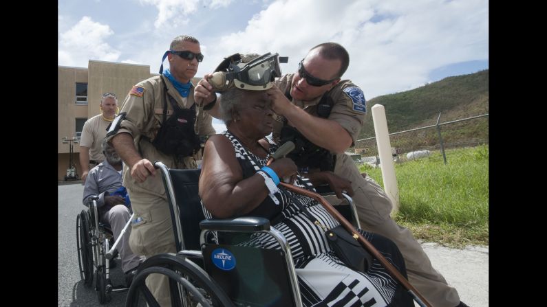 Members of the National Disaster Medical Assistance Team help people evacuate St. Thomas, one of the US Virgin Islands, on Saturday, September 9. The Department of Defense has been supporting the Federal Emergency Management Agency to help those affected by Hurricane Irma.