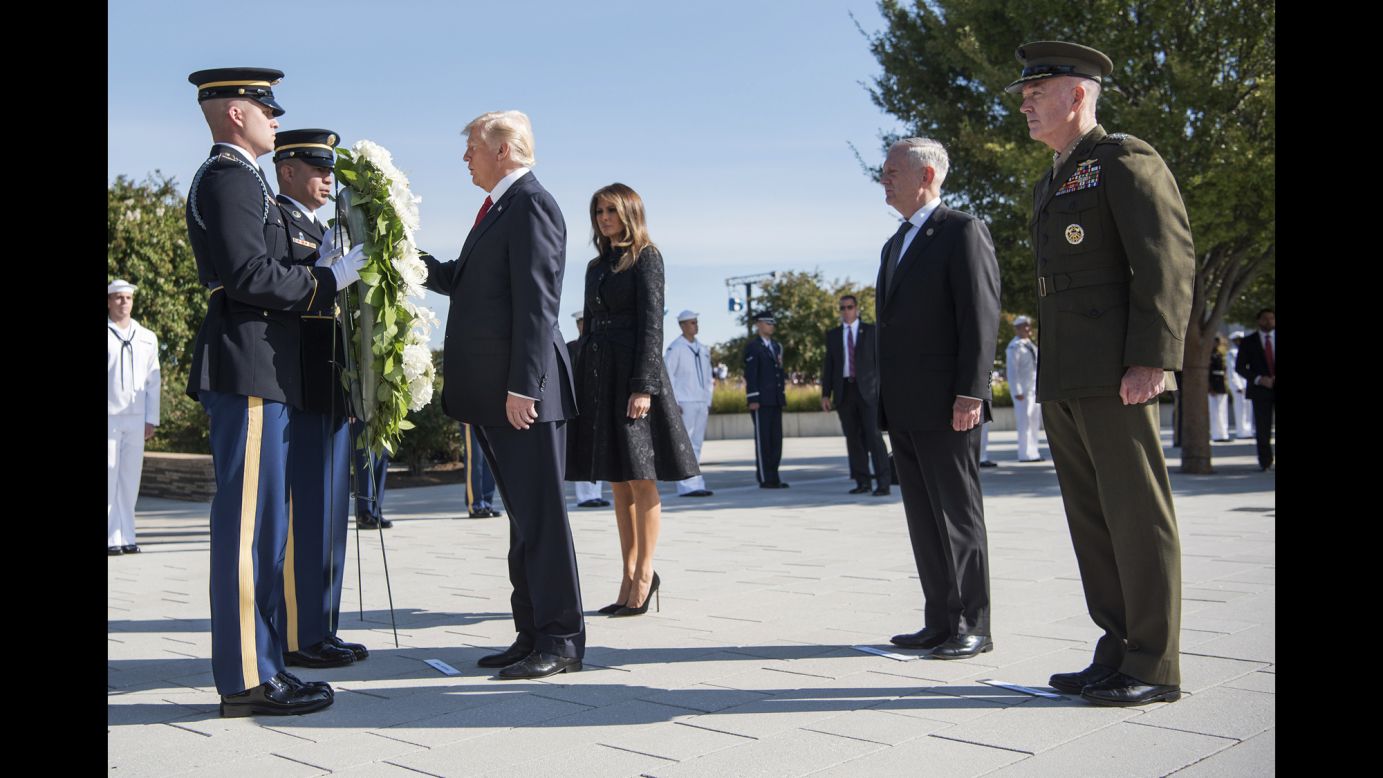 President Donald Trump, accompanied by first lady Melania Trump, participates in a wreath-laying ceremony at the Pentagon, 16 years after the September 11 terrorist attacks.