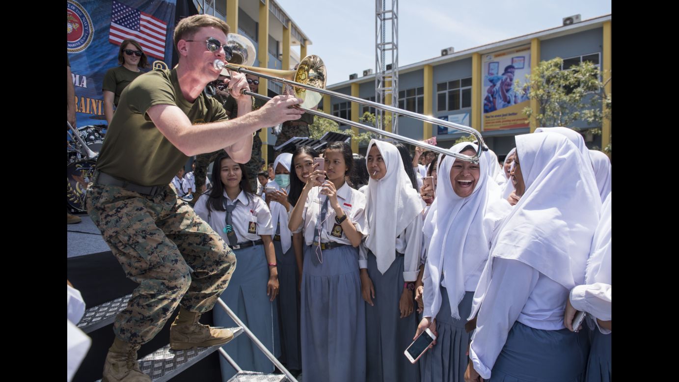 Marine Sgt. Colin Deeter plays the trombone at a high school in Surabaya, Indonesia, where troops from the United States and other countries were taking part in annual training exercises on Tuesday, September 12. Deeter is part of a Marine band, assigned to the 3rd Marine Expeditionary Force, that performs throughout the Far East.