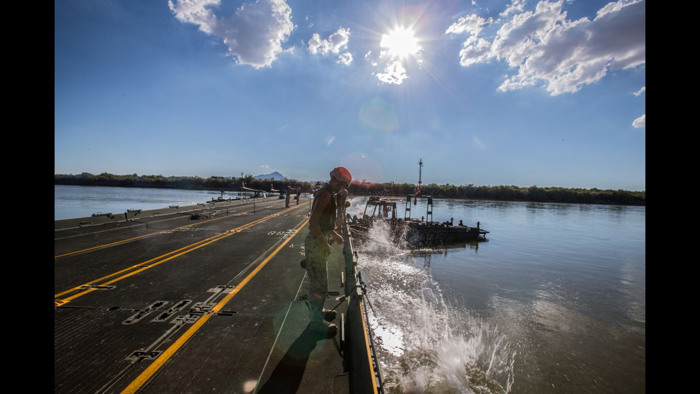 US Marines drop anchors to support a floating bridge in Blythe, California, on Monday, September 11. During a training exercise, they were tasked with constructing a bridge to span a 120-meter (394-foot) section of the Colorado River.