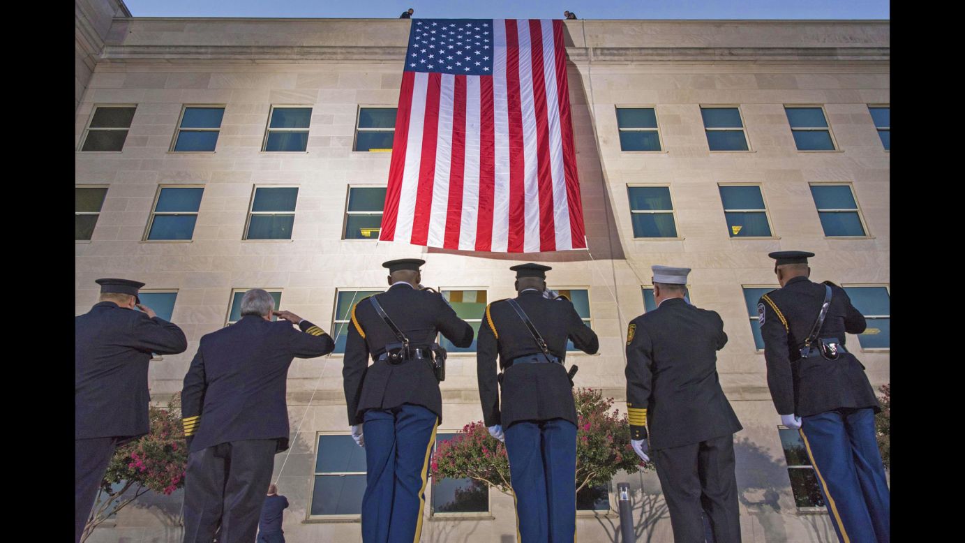 First responders salute a large American flag as it's unfurled over the west side of the Pentagon on Monday, September 11. <a href="http://www.cnn.com/2017/08/31/politics/gallery/us-military-august-photos/index.html" target="_blank">See US military photos from August</a>