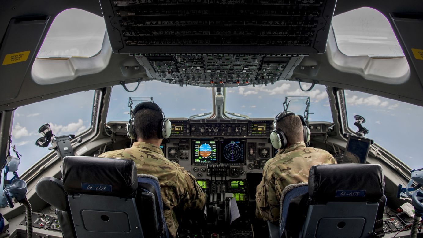 Air Force Capts. Bryan Adams, left, and David Wilfong fly a C-17 Globemaster III to Puerto Rico on Saturday, September 9. They were delivering personnel and equipment to help with Hurricane Irma relief efforts.