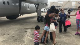 Families saying goodbye before boarding the flight.