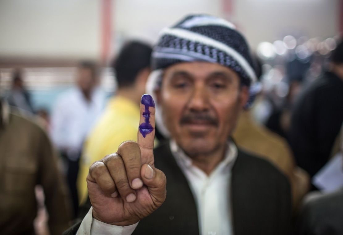 An Iraqi Kurdish man shows his ink-stained finger after voting in the Kurdish independence referendum. 