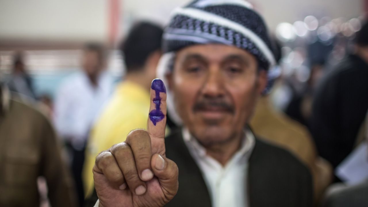An Iraqi Kurdish man shows his ink-stained finger after voting in the Kurdish independence referendum.