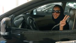 TO GO WITH AFP STORY BY ACIL TABBARA 
Saudi activist Manal Al Sharif, who now lives in Dubai, flashes the sign for victory as she drives her car in the Gulf Emirate city on October 22, 2013, in solidarity with Saudi women preparing to take to the wheel on October 26, defying the Saudi authorities, to campaign women's right to drive in Saudi Arabia. Under the slogan " driving is a choice ", activists have called on social networks for women to gather in vehicles on October 26, the culmination of the campaign launched in September, in the only country in the world where women do not have the right drive. AFP PHOTO/MARWAN NAAMANI        (Photo credit should read MARWAN NAAMANI/AFP/Getty Images)