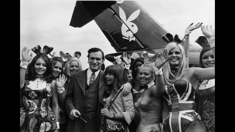 Hefner and his then-girlfriend Barbi Benton pose with Playboy Bunnies at London's Heathrow Airport in 1970.