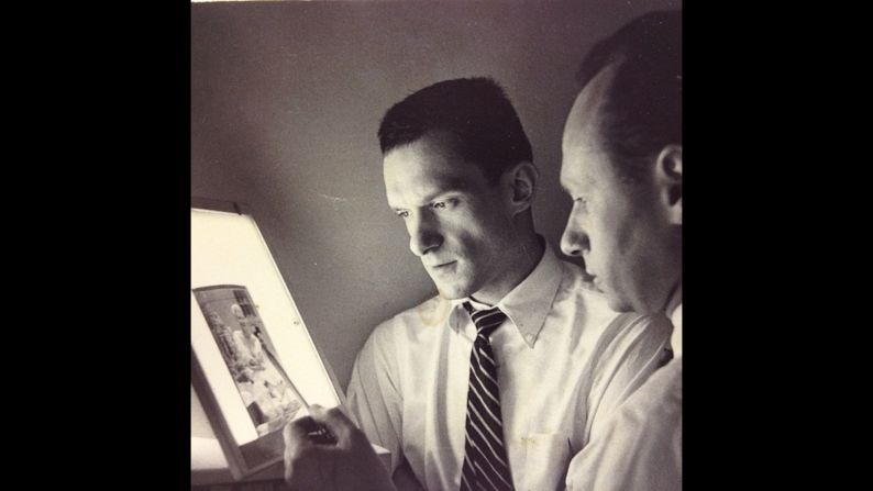 Hefner, left, reviews a negative in 1955. 