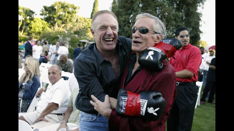 Hefner seen with actor James Cann during Fight Night at the Playboy Mansion on July 15, 2003.