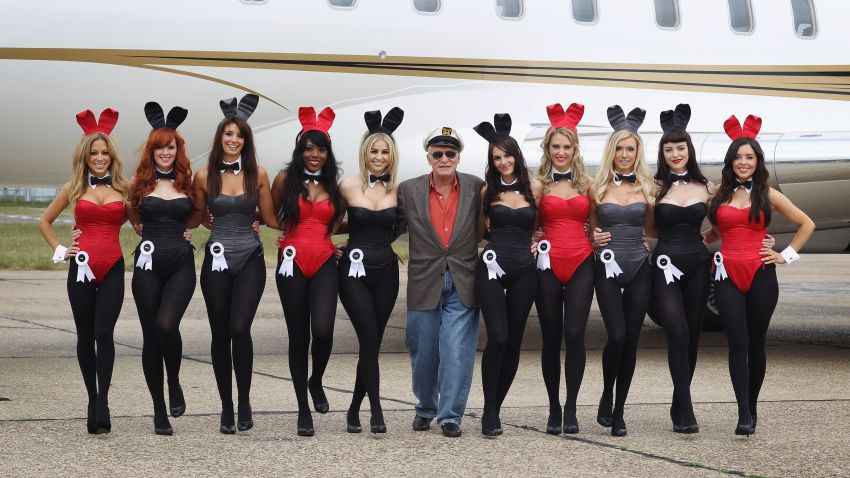 STANSTED, ENGLAND - JUNE 02:  Playboy founder Hugh Hefner (centre) arrives at Stansted Airport on June 2, 2011 in Stansted, England. The photograph is a recreation of a picture originally taken in the 1960's, with ten of the new London Bunnies. Mr Hefner is back in the UK to mark the launch of the new Playboy Club in Mayfair, which opens on June 4. The club's opening will welcome back the iconic Playboy Bunny to London after a 30 year absence. Famous Bunnies have included Debbie Harry and Lauren Hutton.  (Photo by Dan Kitwood/Getty Images)