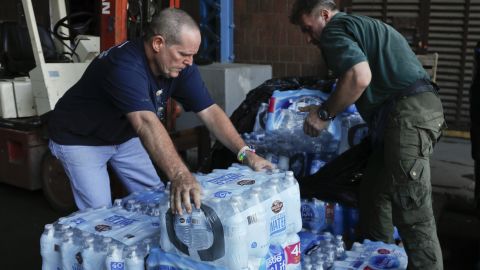 State Park employees in New York stack cases of bottled water that were donated for a relief fund to help Puerto Rico.