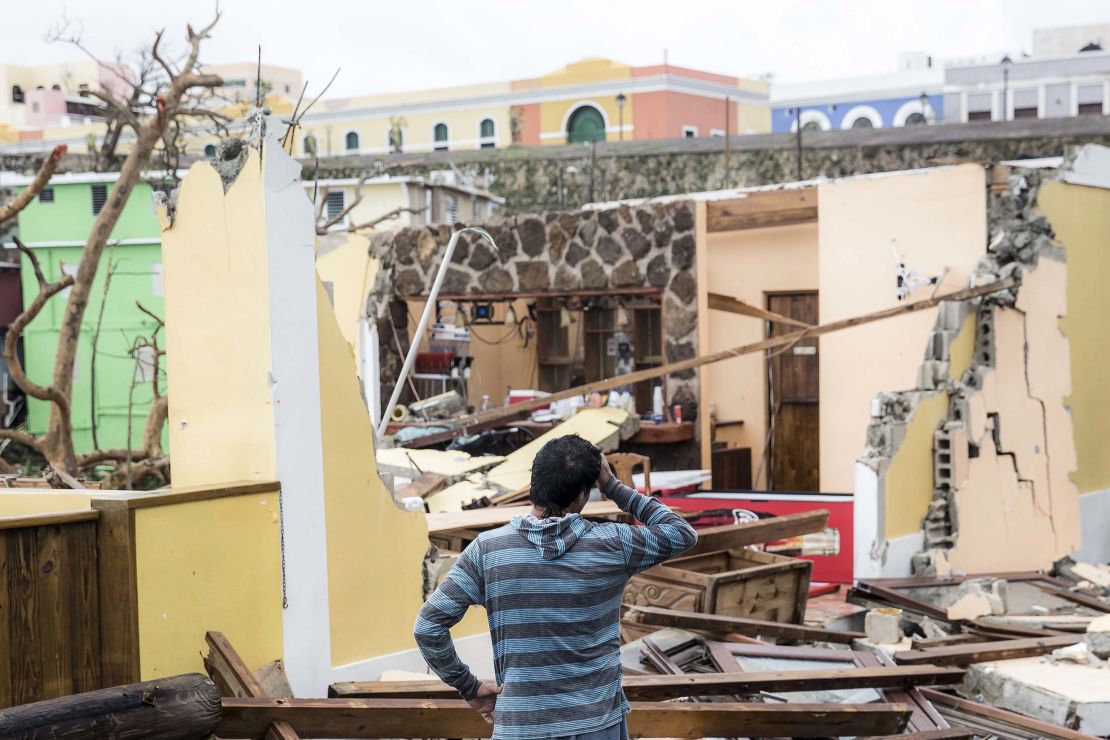 A survivor contemplates property damage in San Juan, Puerto Rico, after Hurricane Maria.