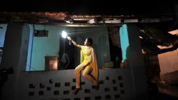 A young girl switches on a light powered by solar energy in the village of Morabandar on Elephanta Island, off the coast of Mumbai.