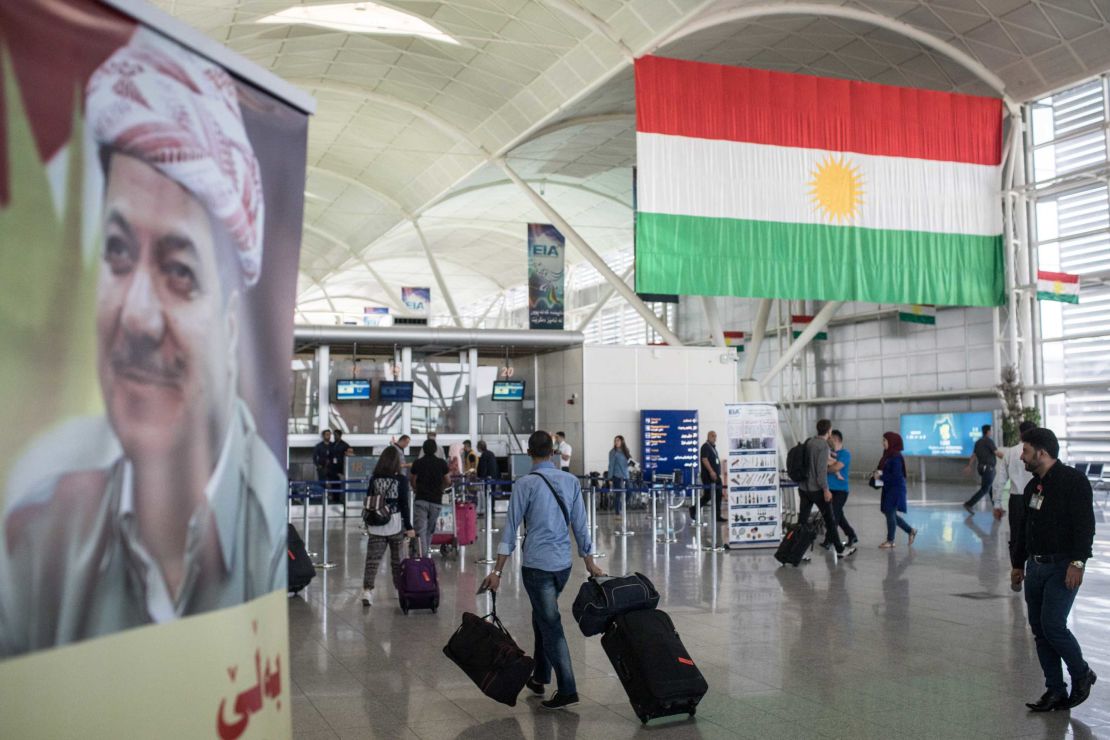Travelers pass through Erbil International Airport on September 27.