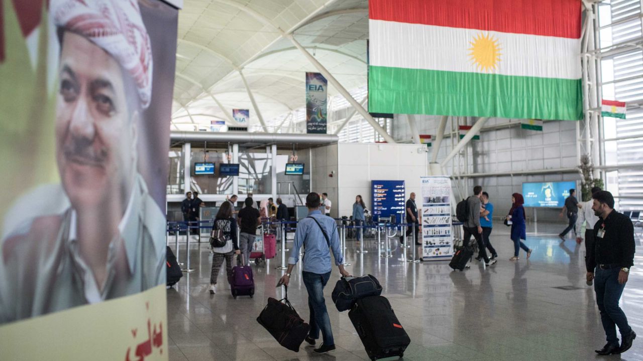 Travelers pass through Erbil International Airport on September 27. 
