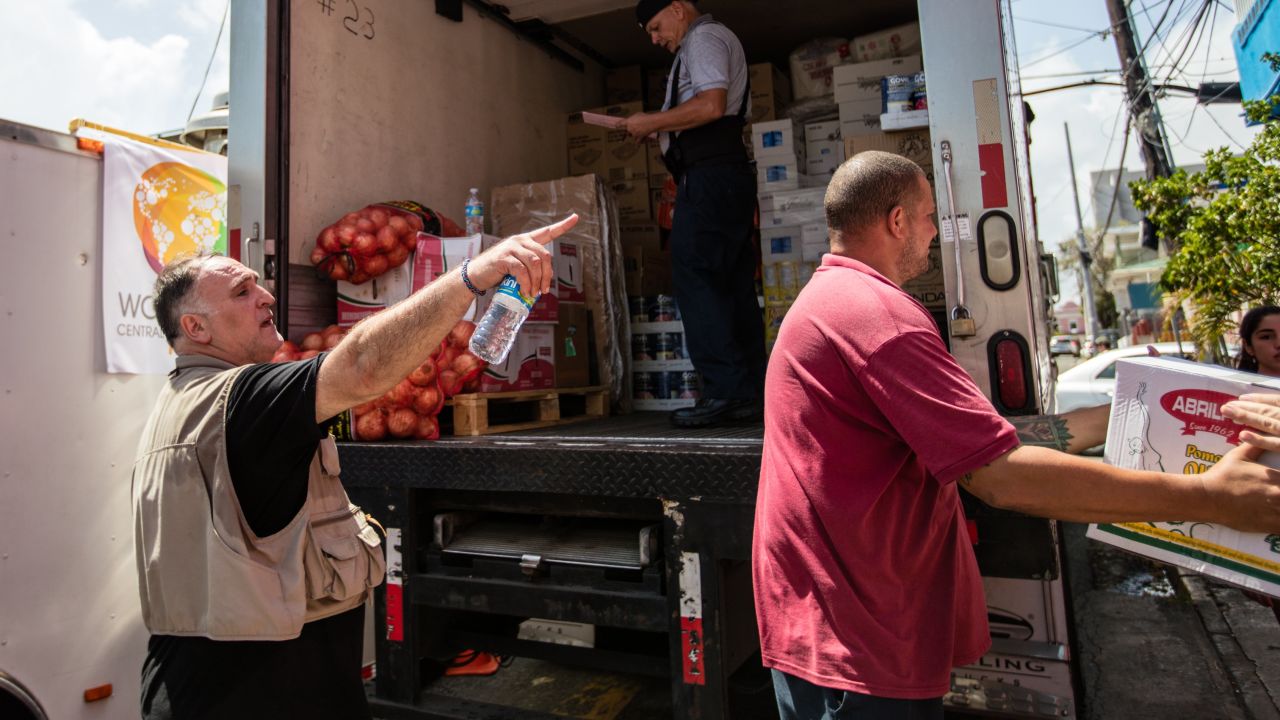 Chef Jose Andres, left, directs volunteers after a delivery of food.