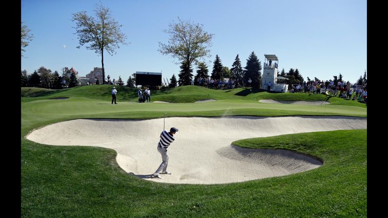 Dustin Johnson hits from a sand trap on the fourth hole during the foursomes. Johnson, the world No.1, and Matt Kuchar beat Adam Scott and Jhonattan Vegas. 