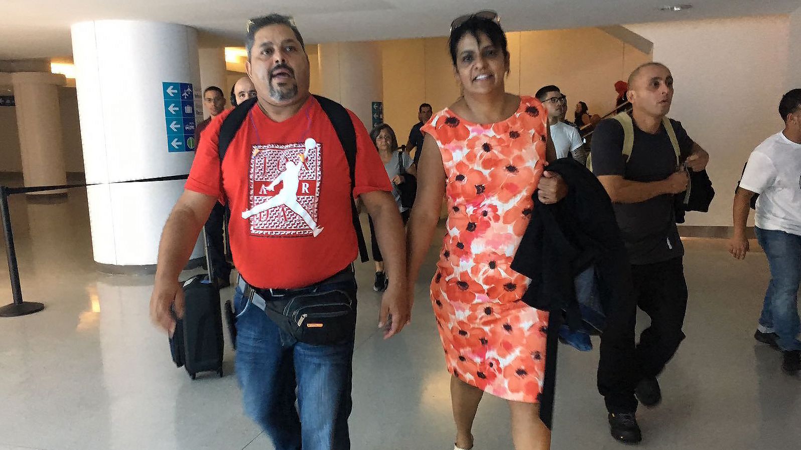 Edgardo and Carmen Delgado are relieved to be back in Puerto Rico after arriving at San Juan's airport.