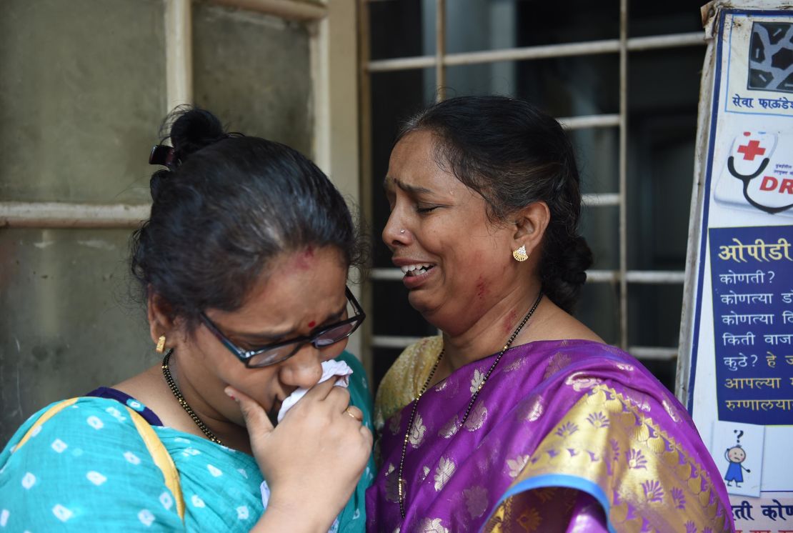 Relatives of victims injured in the stampede react as they wait at a nearby hospital. 