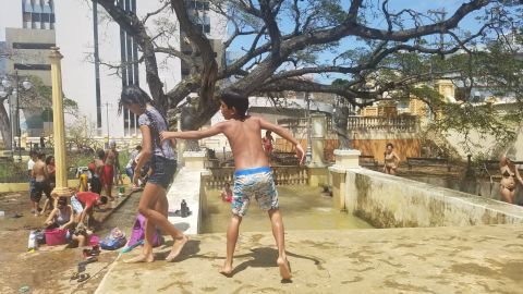 Children bathe in the water from a flooded plaza in Aguadilla, a coastal town in western Puerto Rico.