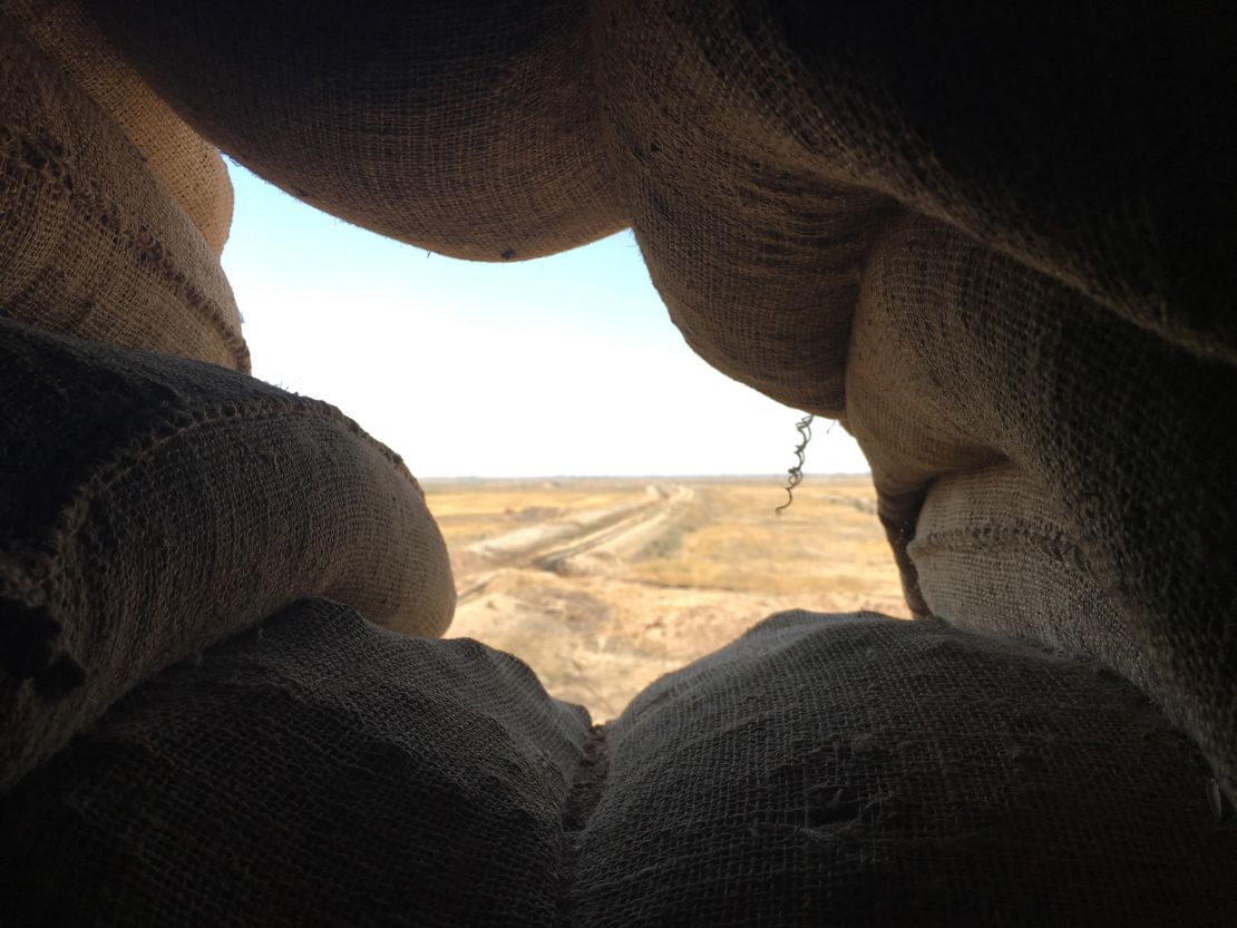 The view from a sandbag sentry position looks out at ISIS territory in the distance. 