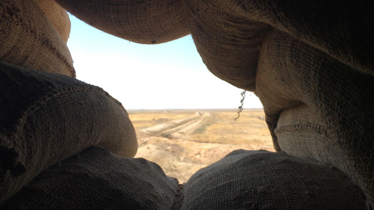 The view from a sandbag sentry position looks out at ISIS territory in the distance.