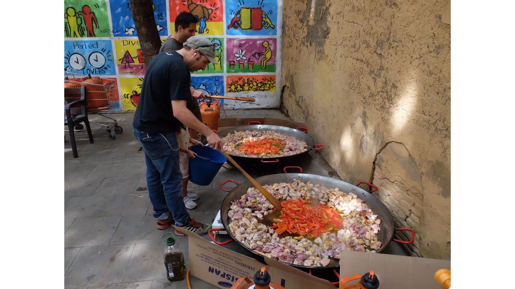 Volunteers cook giant dishes of paella to feed those occupying one Barcelona school on Saturday.