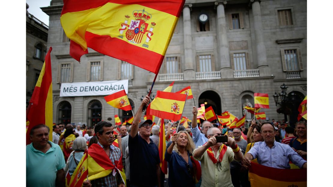 People wave Spanish flags while demonstrating against Catalonia's independence referendum in Barcelona on Saturday.