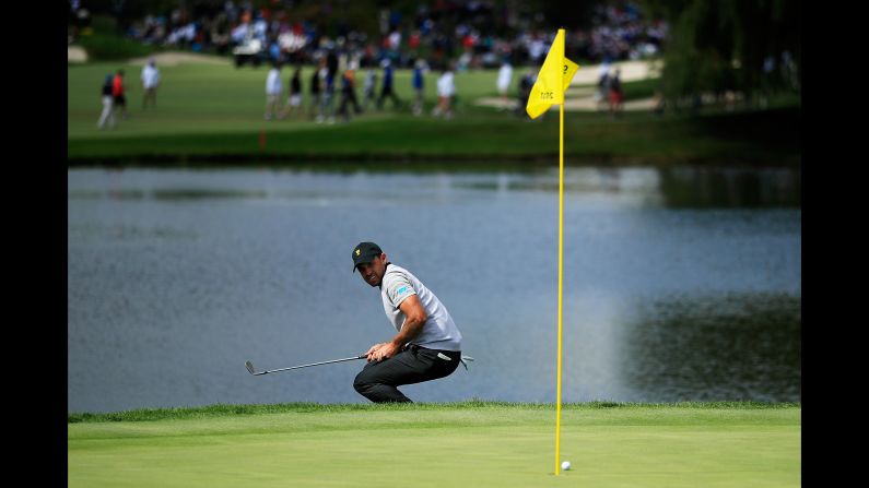 Charl Schwartzel of South Africa and the International Team reacts to a shot on the second hole during Friday four-ball matches of the Presidents Cup at Liberty National Golf Club on September 29, 2017 in Jersey City, New Jersey.  (Photo by Cliff Hawkins/Getty Images)