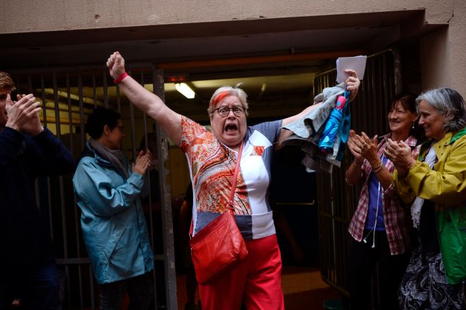 A woman celebrates outside a polling station after casting her vote in Barcelona, on October 01 in a referendum on independence for Catalonia.