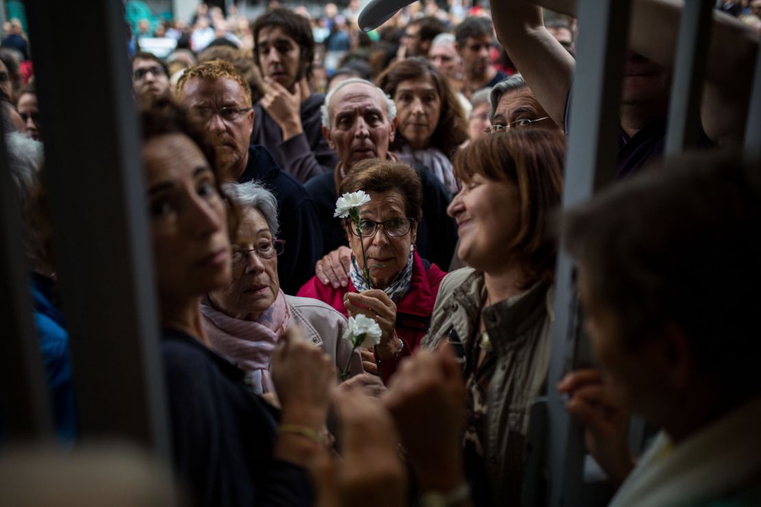 People wait at the doors of a school in Barcelona to start voting during the Catalan independence referendum.