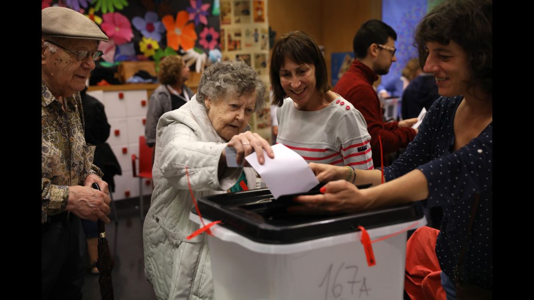 A woman casts her vote at a polling station in Barcelona.