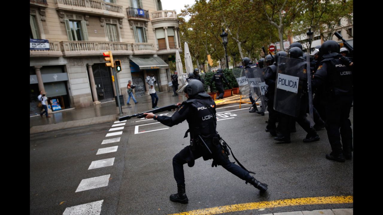 Spanish riot police shoot rubber bullets at people trying to reach a voting site designated by the Catalan government in Barcelona. The deputy mayor of Barcelona said police fired rubber bullets at people as they attempted to vote in the referendum, which Spain's top court has declared illegal. There were reports that police in Girona, Spain, used batons.