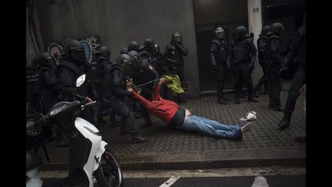 Riot police drag a member of the public away from a school being used as a polling station. Regional authorities said 337 people were injured after Madrid deployed the national police force to close down polling stations. Catalan emergency services confirmed the number to CNN.