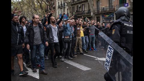 Pro-referendum supporters clash with members of the Spanish National Police after police tried to enter a polling station to retrieve ballot boxes.