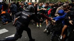 Spanish National Police clashes with pro-referendum supporters in Barcelona Sunday, Oct. 1 2017. Catalonia's planned referendum on secession is due to be held Sunday by the pro-independence Catalan government but Spain's government calls the vote illegal, since it violates the constitution, and the country's Constitutional Court has ordered it suspended. (AP Photo/Manu Fernandez)