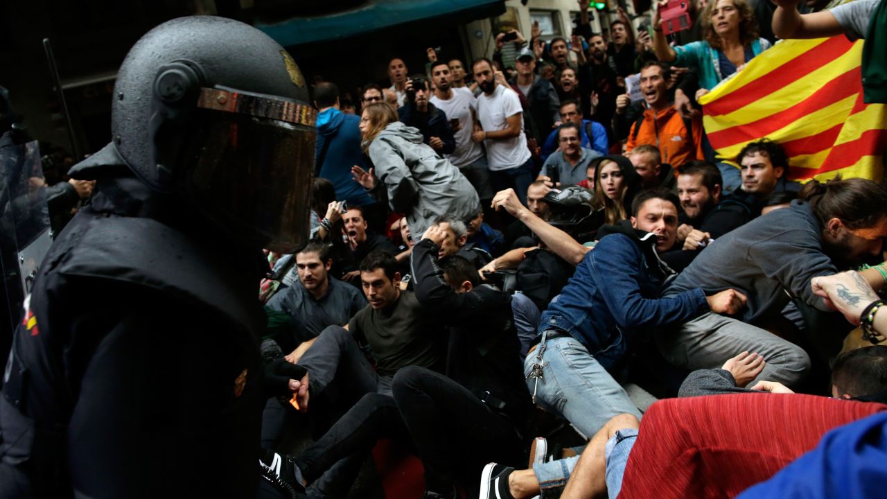 Spanish National Police clash with pro-referendum supporters in Barcelona.