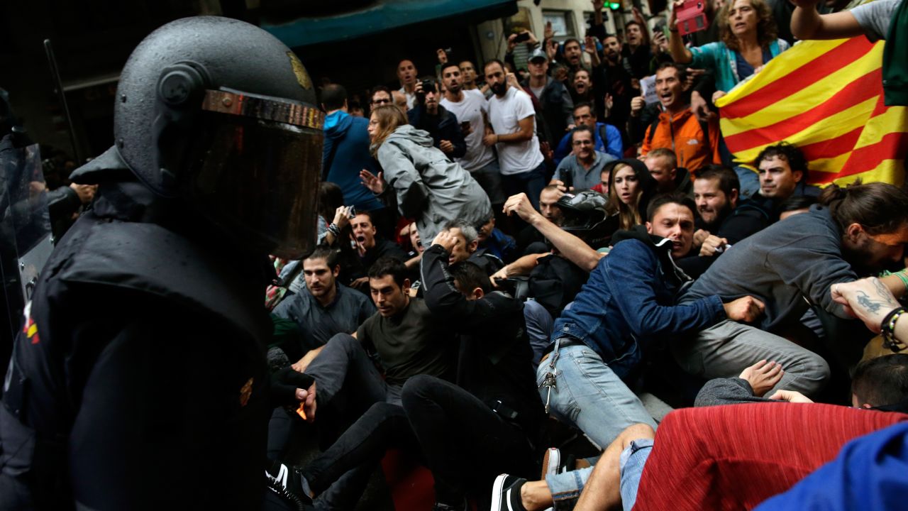 Spanish National Police clash with pro-independence supporters in Barcelona on October 1.