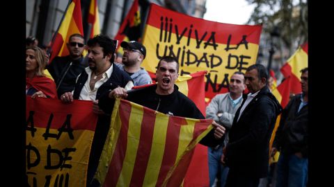 A protestor shouts as he holds a Catalan flag during a demonstration called by far-right groups in Barcelona.