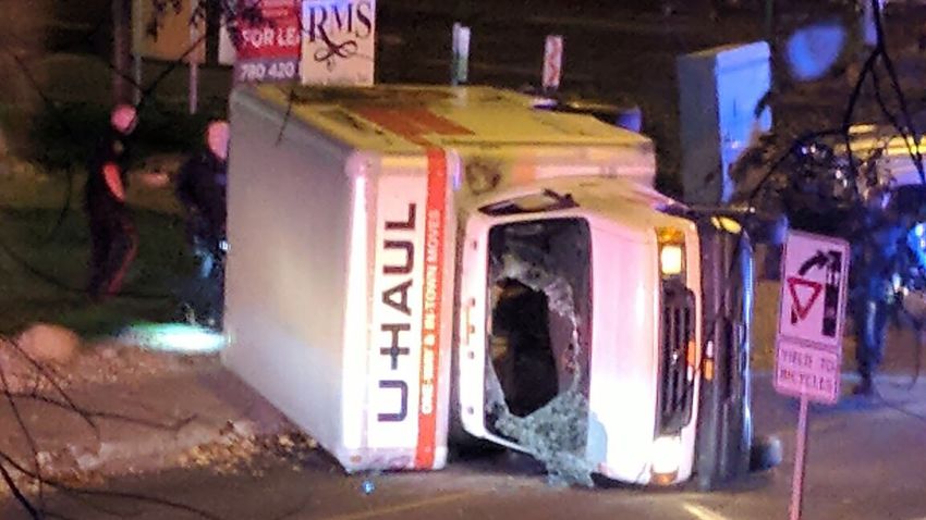 A rental truck lies on its side in Edmonton, Canada, on October 1, 2017, after a high speed chase.
Canadian police arrested a man early Sunday suspected of stabbing an officer and injuring four pedestrians in a series of violent incidents being investigated as an "act of terrorism." The crime spree began late September 30 outside a football stadium and ended hours later with a high speed chase in which the driver of the rented truck plowed into pedestrians, police said.
 / AFP PHOTO / Michael MUKAI        (Photo credit should read MICHAEL MUKAI/AFP/Getty Images)