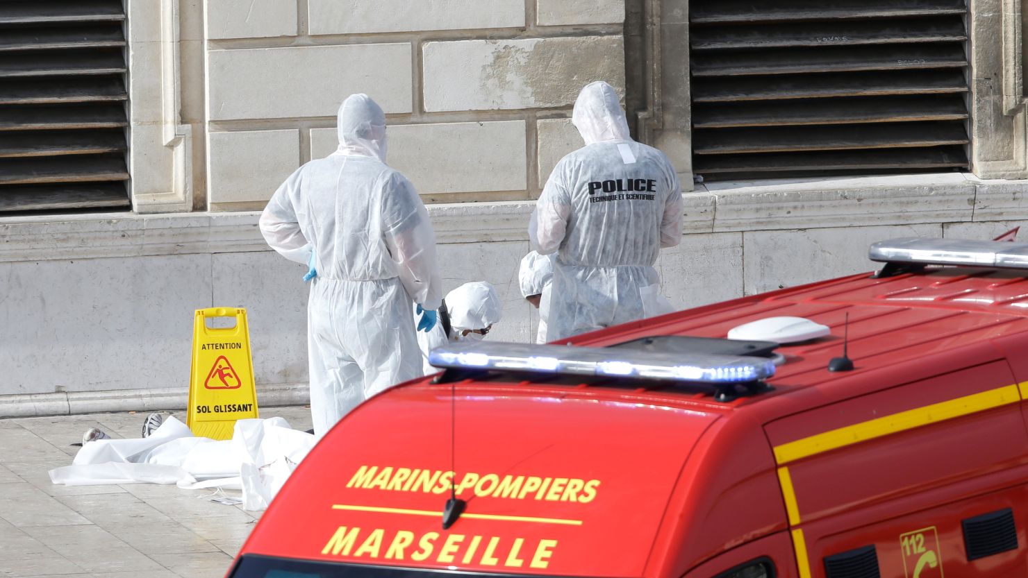 Police stand over a body after a man stabbed two women to death on Sunday at a train station in Marseille, France.