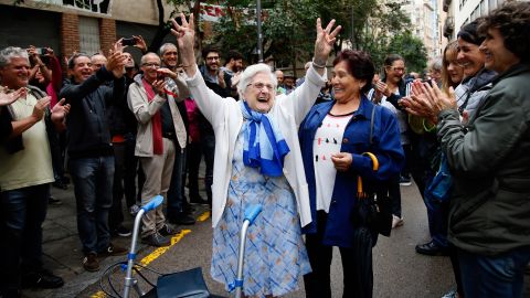 A woman celebrates after voting at a polling station in Barcelona on October 1.